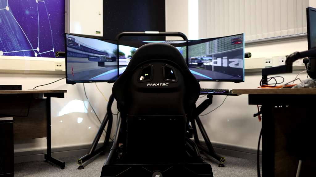A sim rig with a triple-screen setup.